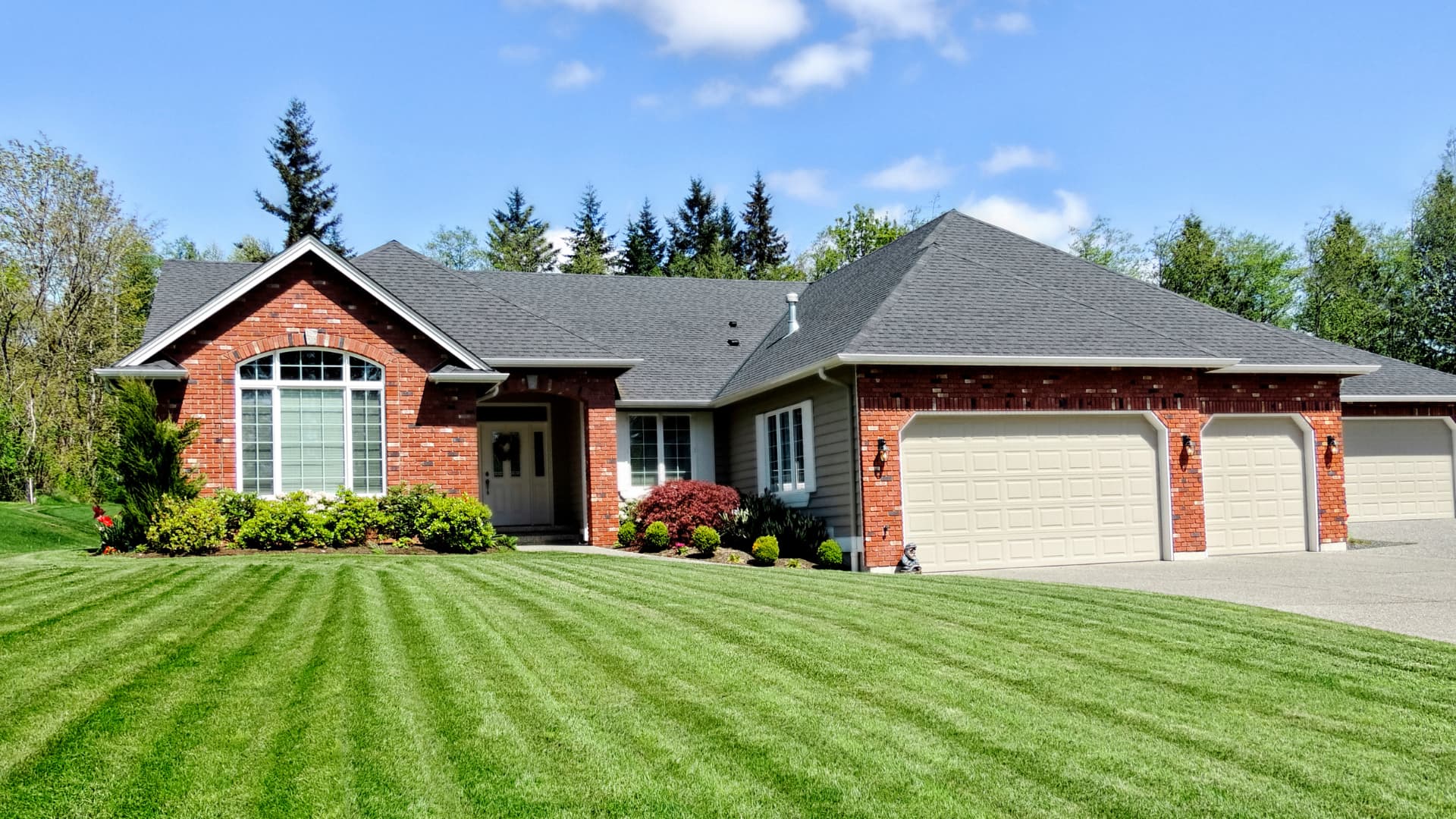 Freshly striped front lawn after an ACME mowing visit